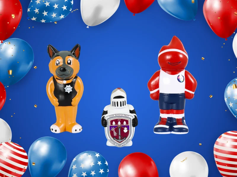 Three inflatable figures—a police dog, a knight with a shield, and a red cartoon character—surrounded by red, white, and blue balloons on a blue background.